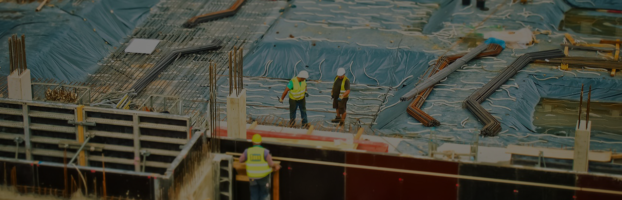 Group of three people on a construction site