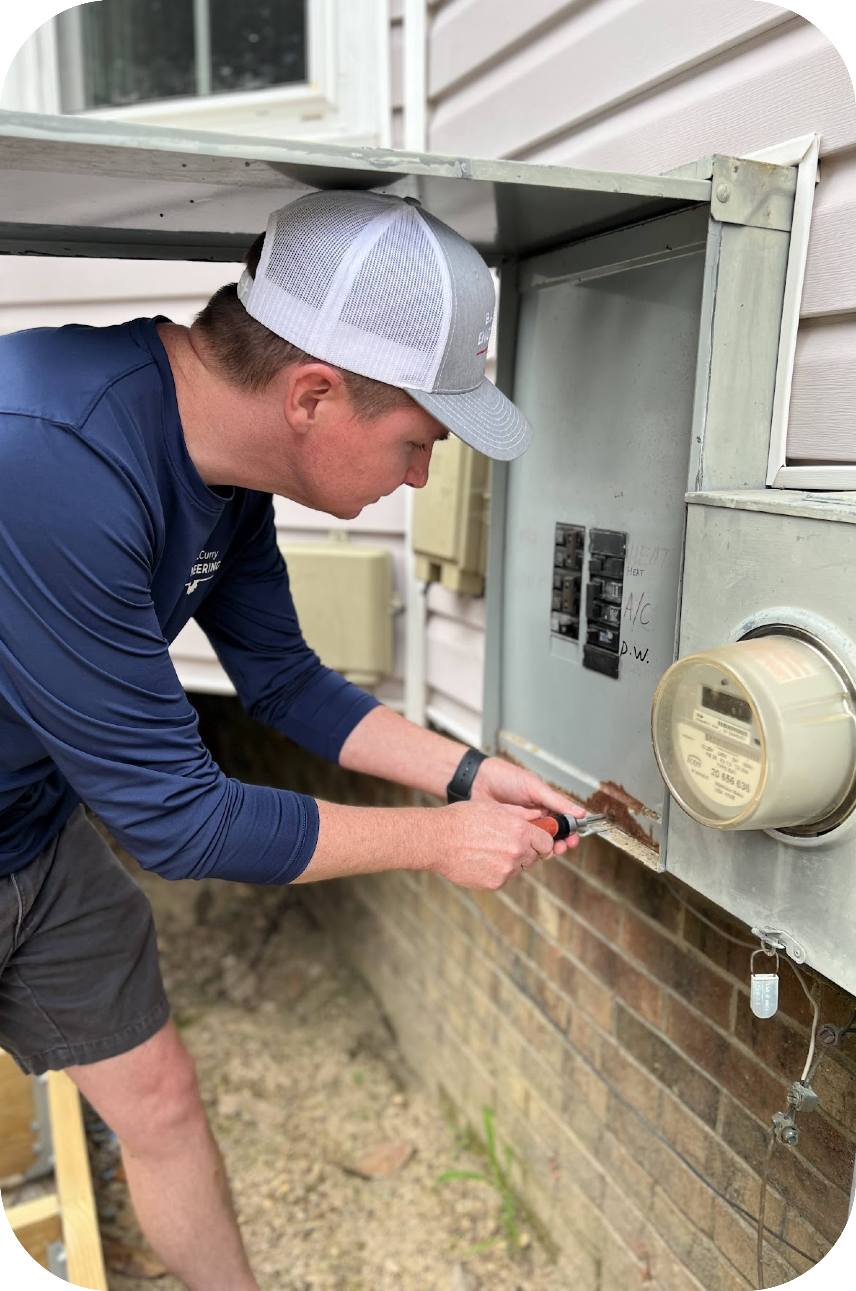 Employee checking the electrical panel of a residential house